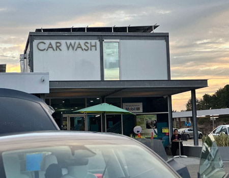 Fashion Square Car Wash building exterior at dusk