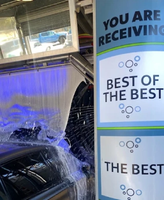 Car going through the wash tunnel at Fashion Square Car Wash with Best of the Best award signage