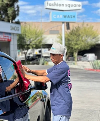 Fashion Square Car Wash attendant hand-drying a customer's car window